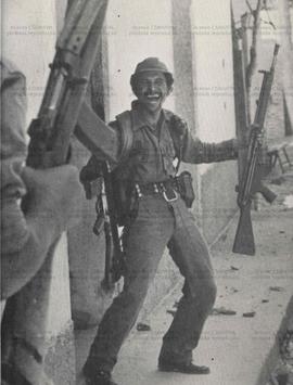 Cartão Postal El Salvador, “Combatente da BRAZ do FMLN sorri, depois do aniquilamento e recuperação de armas à ditadura no Quartel de Corinto (Morazán-El Salvador, 1983). / Crédito: Autoria desconhecida/Comin